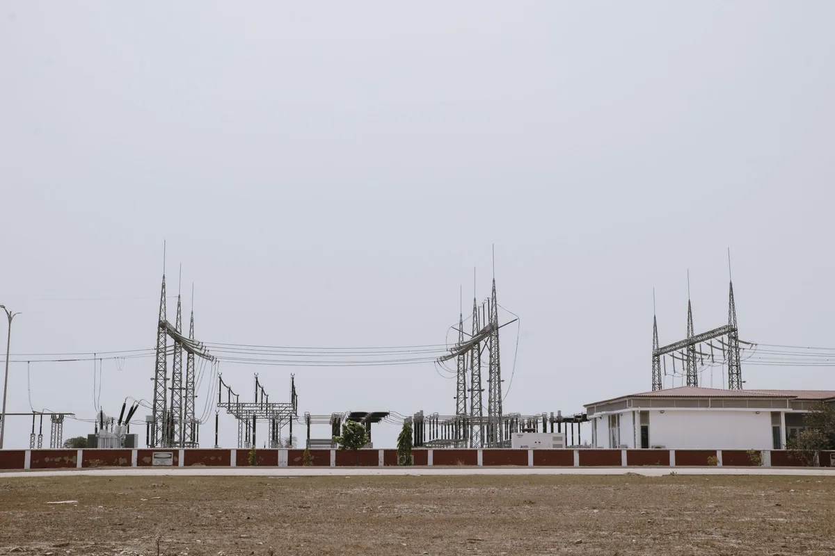 High-voltage substation and transmission gantries supplying an industrial site for peak shaving