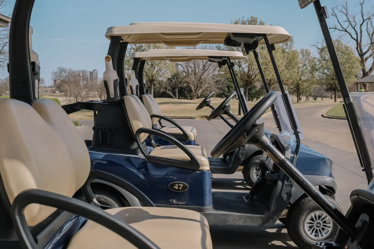 Row of parked golf carts staged for fast rental turnaround