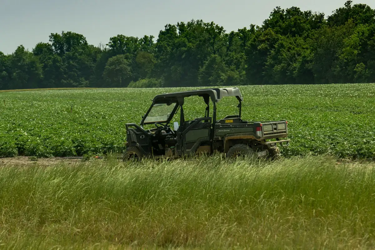 Utility vehicle working in an open field, illustrating heavy-duty auxiliary loads