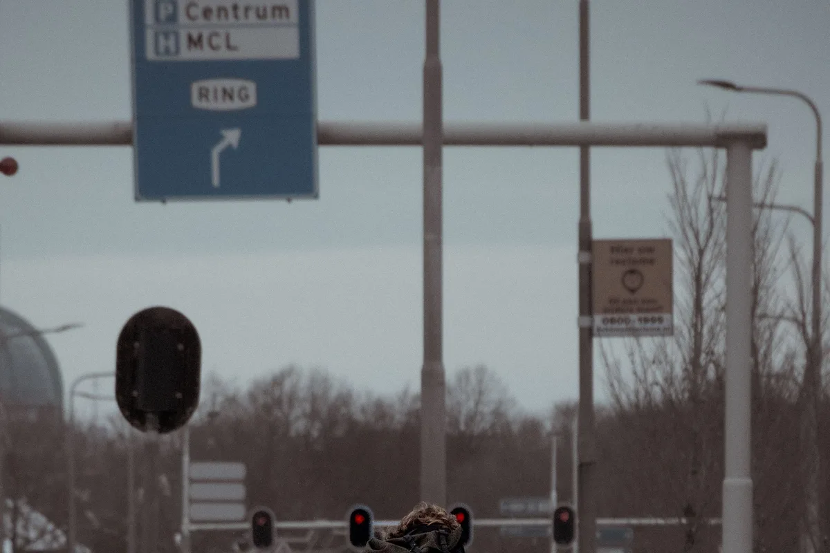 Rider commuting by bicycle on a wet urban road, illustrating daily deep-cycle duty